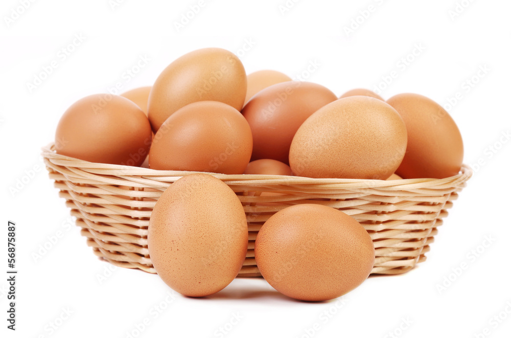 Brown eggs in the basket on white Brown eggs in the basket on white
