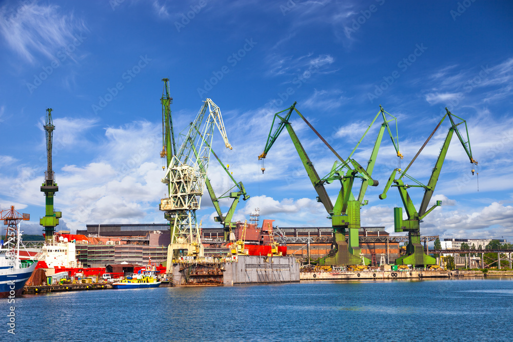 Obraz premium Big cranes and dock at the shipyard of Gdansk, Poland.