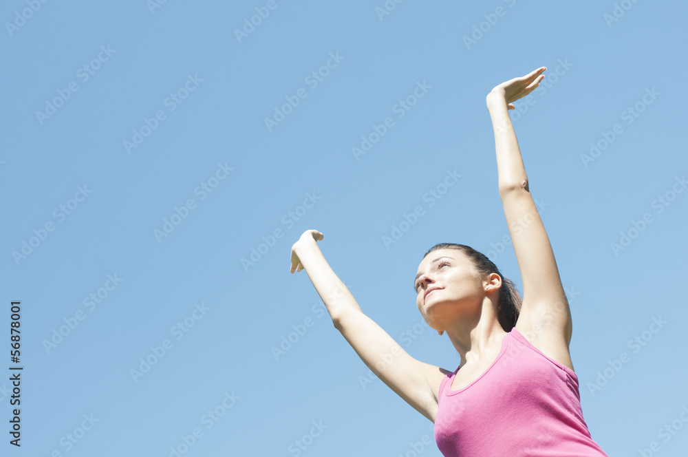 isolated girl jumping of happiness under a blue sky isolated girl jumping of happiness under a blue sky