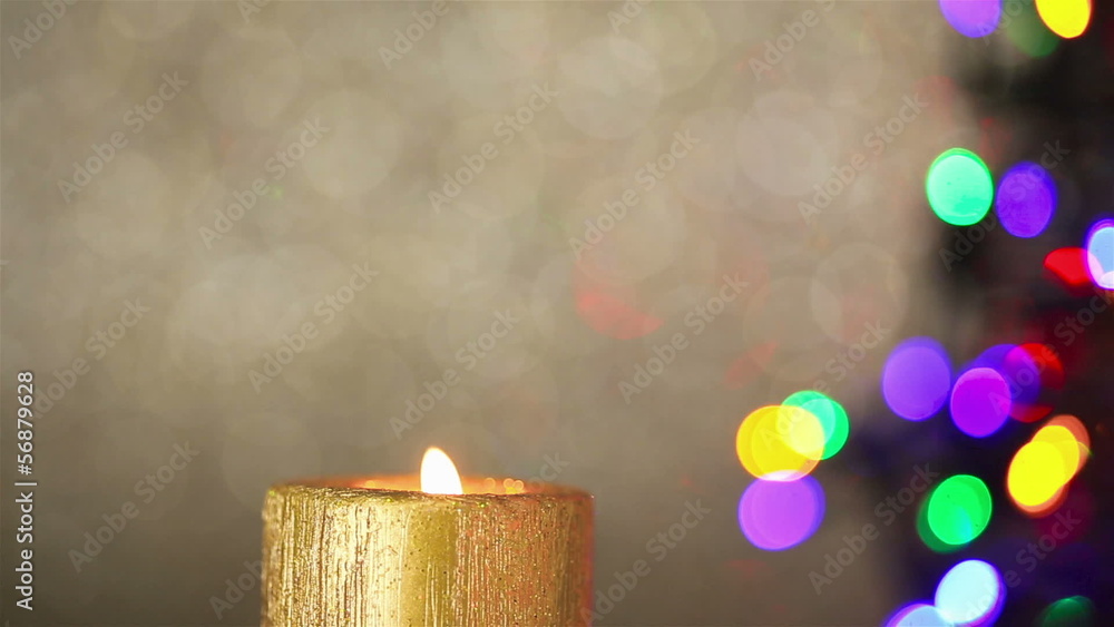 Candle with christmas tree lights in background Stock Video | Adobe Stock