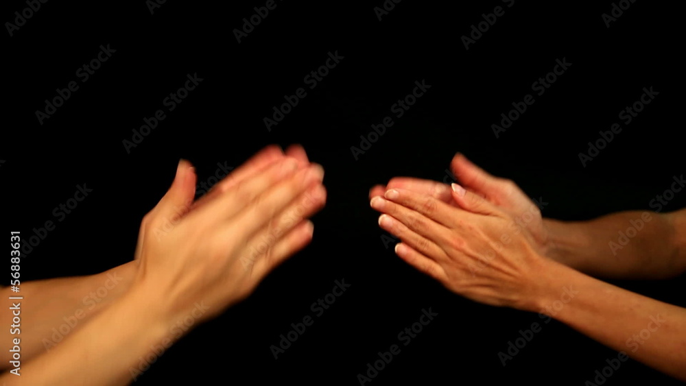 two females are playing a hand clapping game