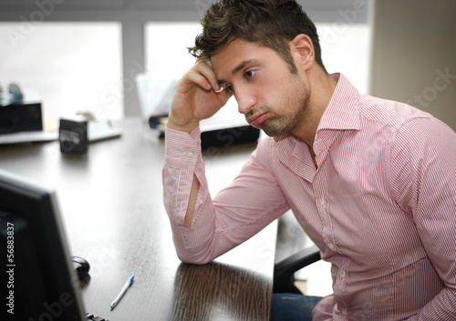 Tired or frustrated office worker looking at computer screen