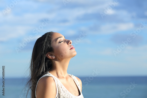Beautiful arab woman breathing fresh air in the beach