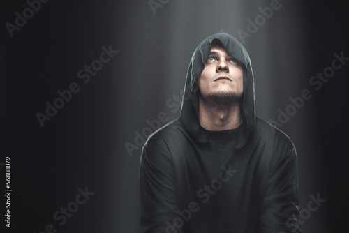 a guy in a black robe standing in the dark
