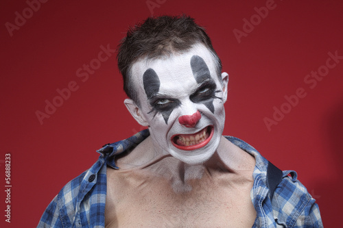 Spooky Clown Portrait on Red Background © Katrina Brown