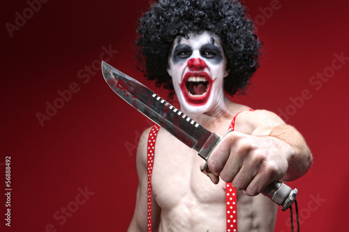 Spooky Clown Holding a Bloody Knife