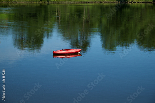 Red Kayak in a calm protective cove in New England