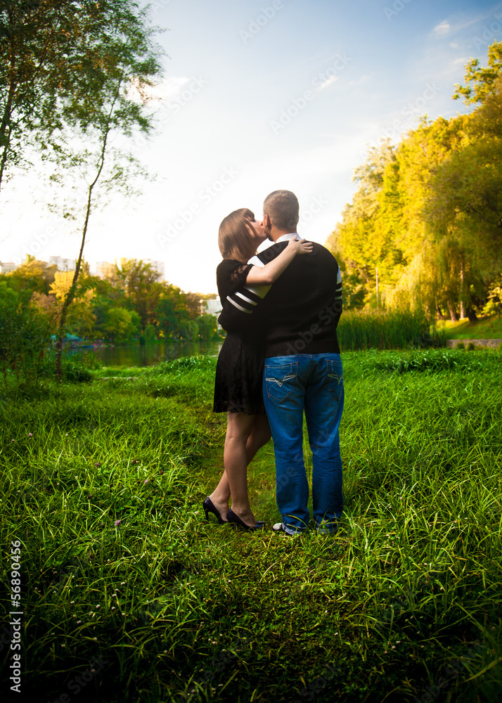 Beautiful girl kissing boyfriend from back Beautiful girl kissing boyfriend from back