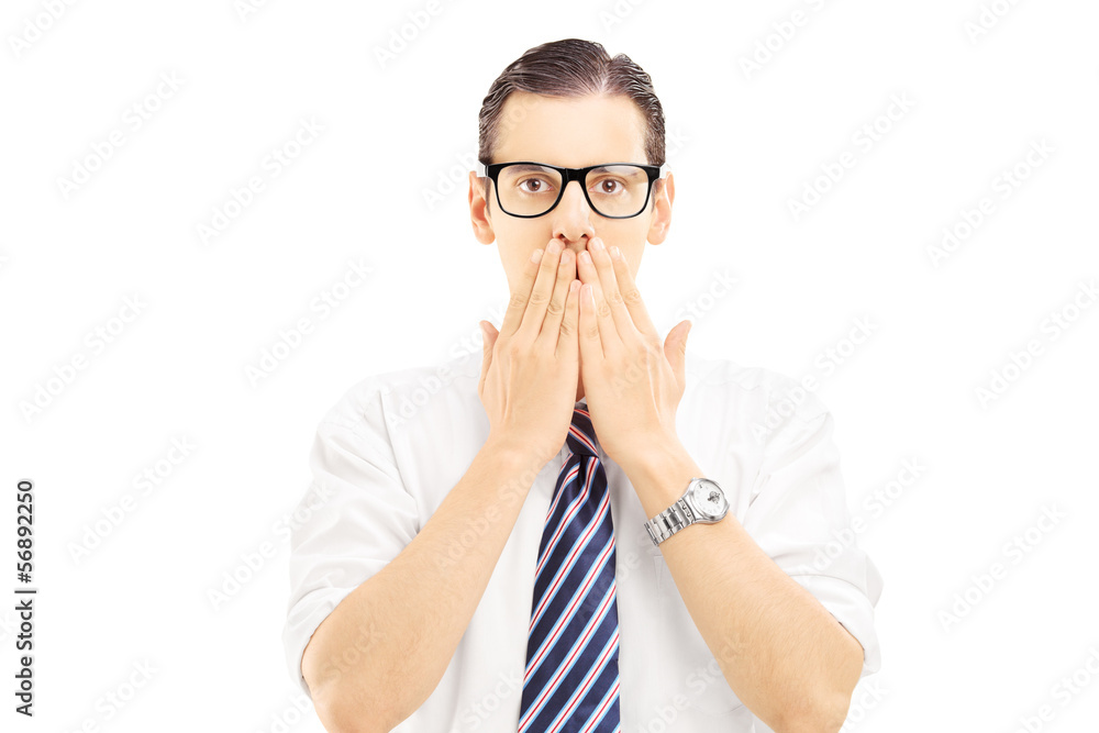 Young man with hands over his mounth, stunned and speechless