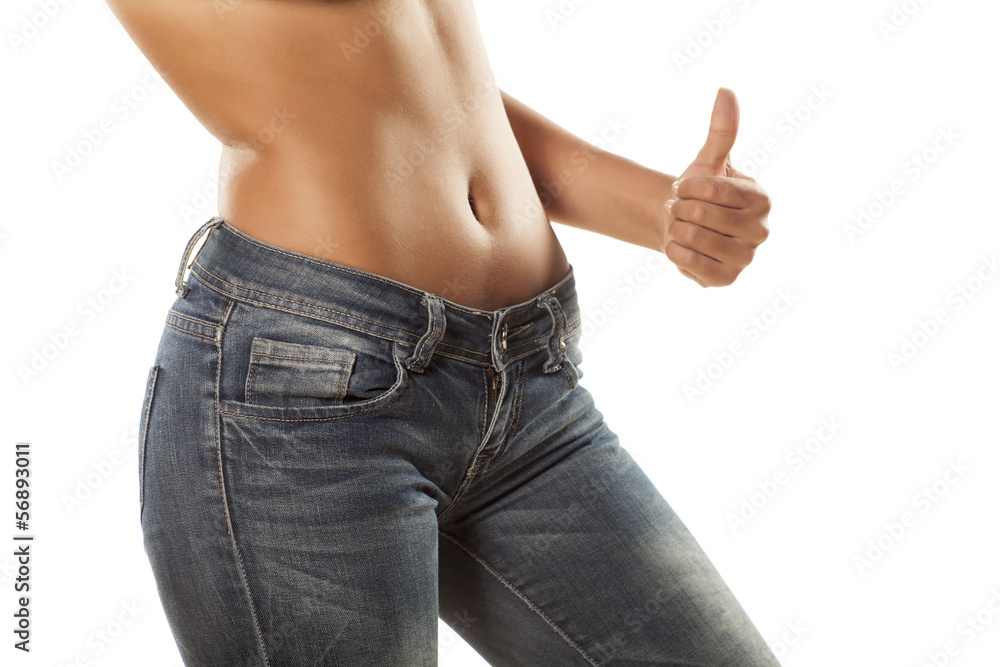 Foto Stock pretty girl with bare belly in tight jeans showing thumbs up |  Adobe Stock