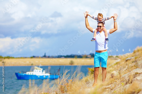 happy father and son enjoying seaside landscape