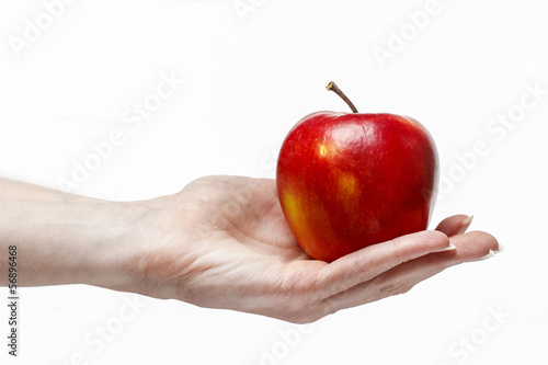 Woman holding red ripe apple in beautiful hand