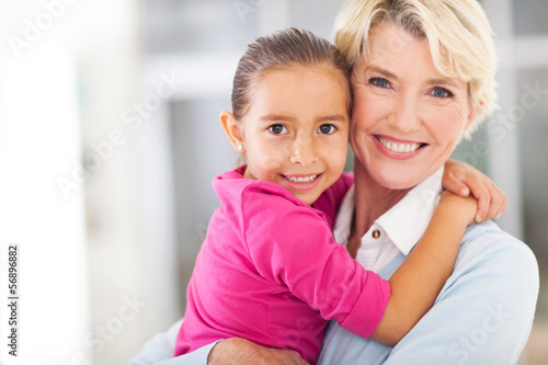 happy grandmother with granddaughter embracing