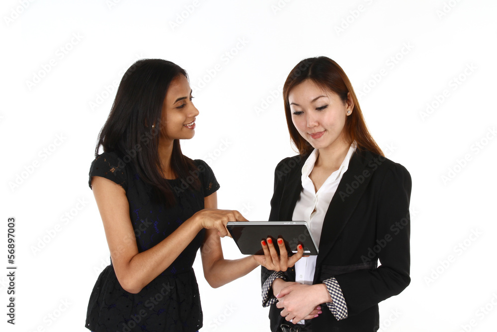 Two happy young Asian business women presenting. Two happy young Asian business women presenting.