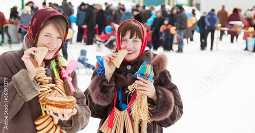  girls eating pancake during  Shrovetide