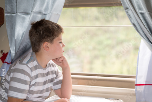 The boy looks in train window
