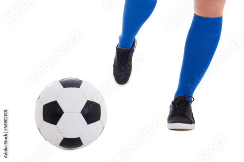 leg of soccer player in blue gaiters kicking ball isolated on wh