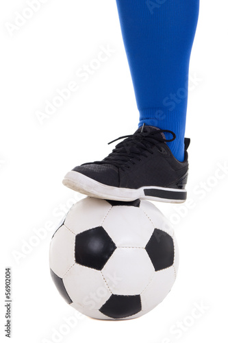 leg of soccer player in blue gaiter with ball isolated on white