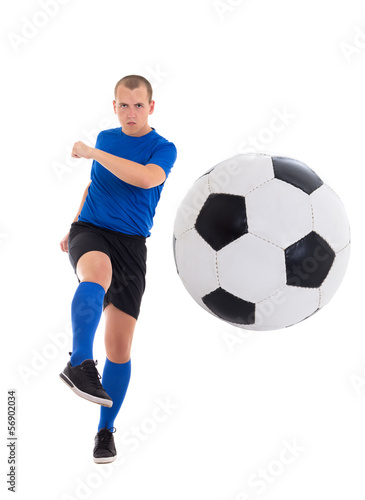 young attractive soccer player in blue uniform kicking ball isol