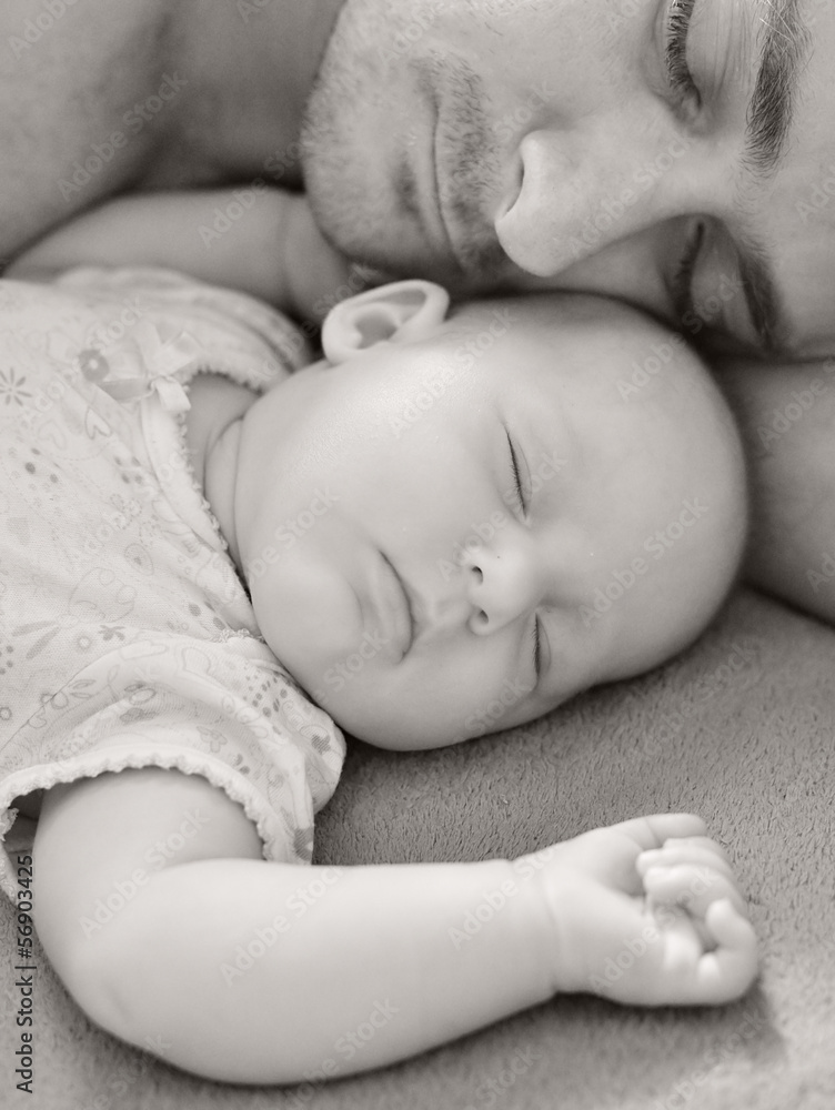 Father sleep with his baby.