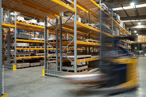 A forklift driving through a warehouse