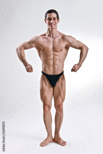 attractive male body builder  demonstrating contest pos