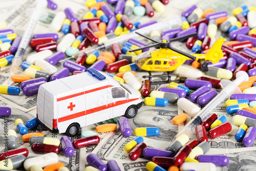 Ambulance car and helicopter toys through dollars and pills