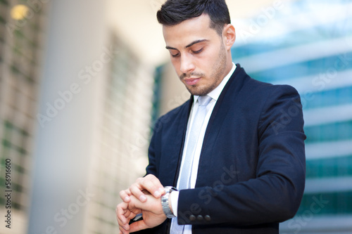 Portrait of smart businessman watching the time