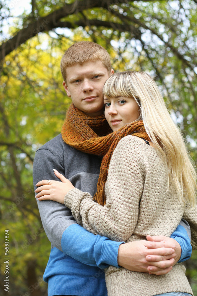 Fototapeta premium young couple together in love hugging in autumn