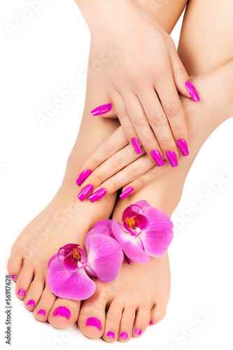 Relaxing pink manicure and pedicure with a orchid flower