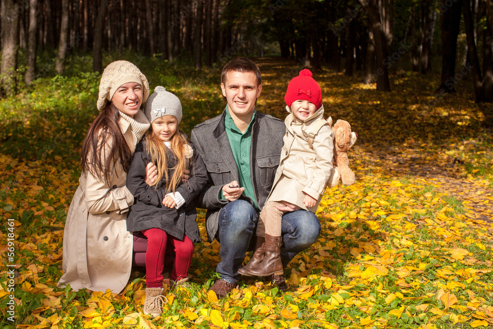 Adorable family of four enjoying a wonderful sunny autumn day in Adorable family of four enjoying a wonderful sunny autumn day in