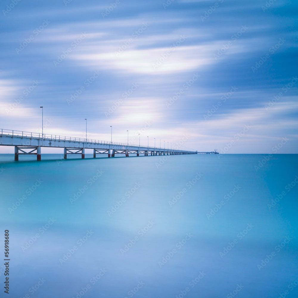 Industrial pier on the ocean. Long exposure photography.