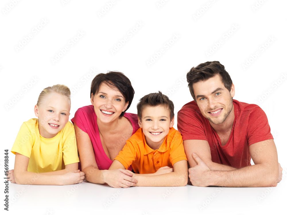 happy family with two children lying on white floor happy family with two children lying on white floor