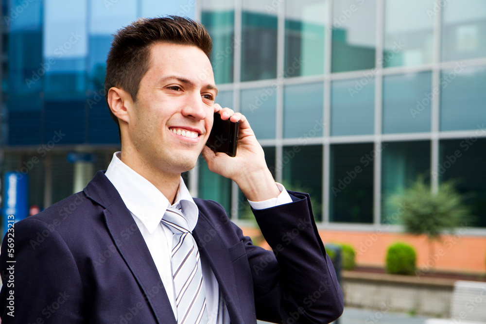 Portrait of a young businessman talking on the phone Portrait of a young businessman talking on the phone