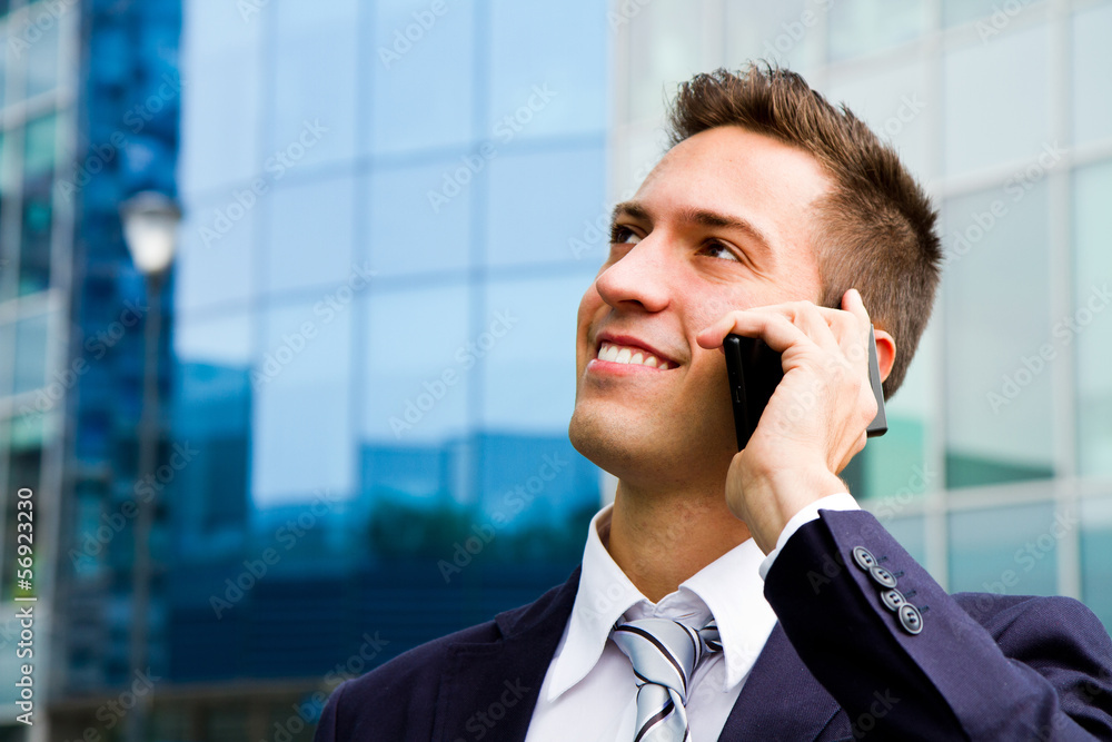 Portrait of a young businessman talking on the phone Portrait of a young businessman talking on the phone