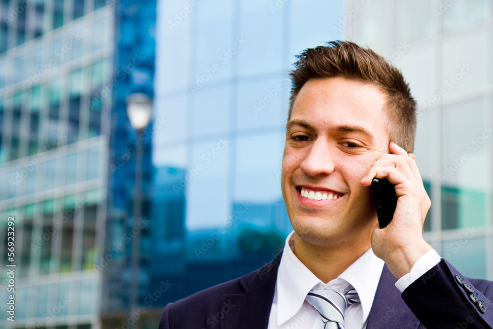 Portrait of a young businessman talking on the phone Portrait of a young businessman talking on the phone