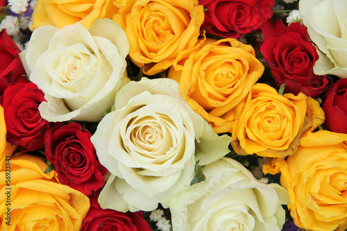 Yellow  white and red roses in a wedding arrangement