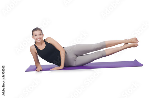 Young female doing exercises on white