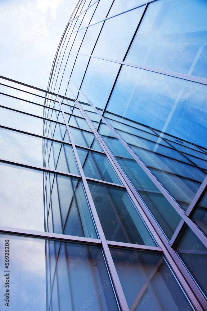 Obraz premium facade of modern glass blue office and sky