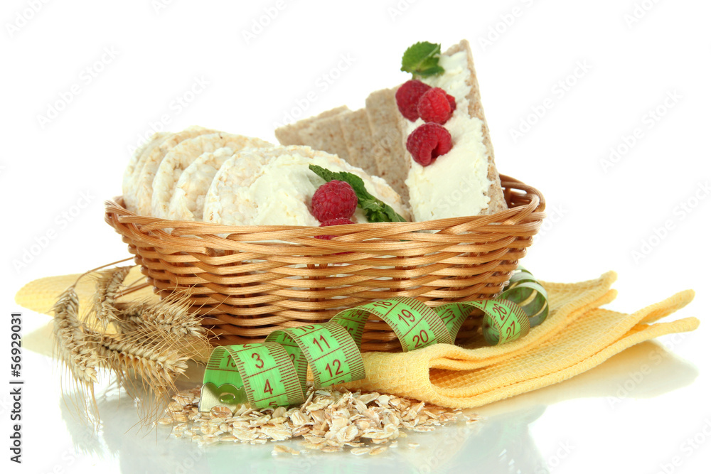 Tasty crispbread with berries in wicker basket, isolated