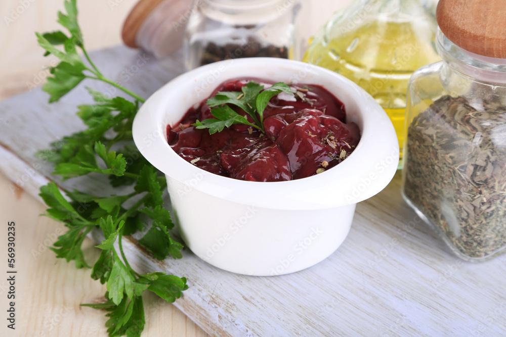 Raw liver in bowl with spices and condiments Raw liver in bowl with spices and condiments