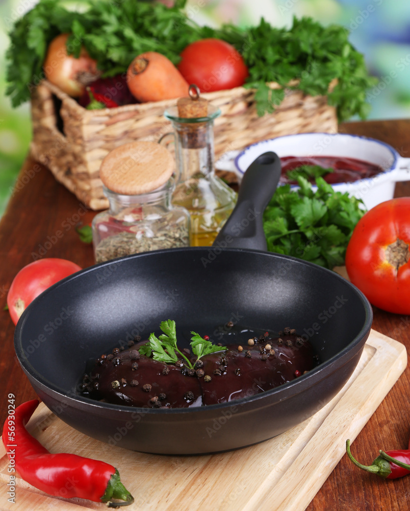Raw liver in pan with spices and condiments Raw liver in pan with spices and condiments