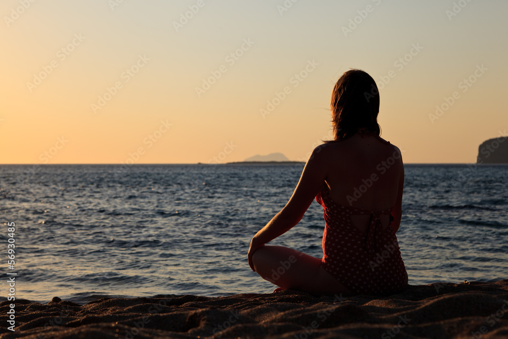 Woman meditation on the beach