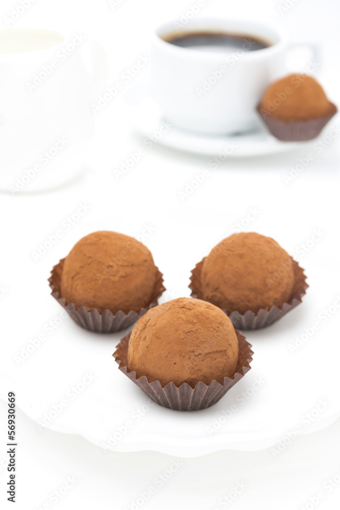 chocolate truffles and a cup of coffee on a white background chocolate truffles and a cup of coffee on a white background