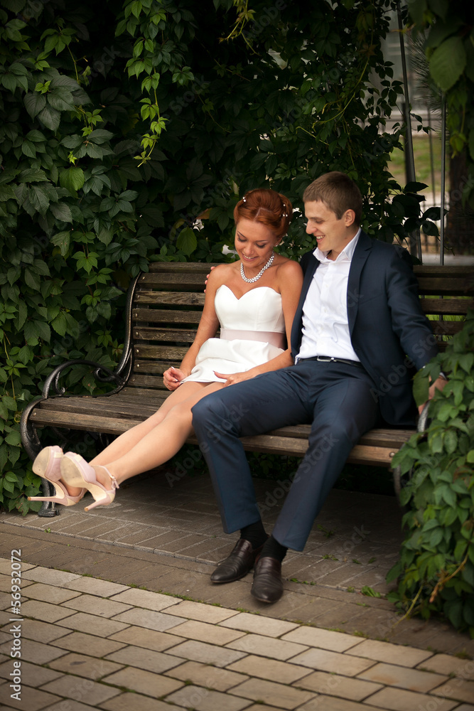 Beautiful couple in love sitting on bench Beautiful couple in love sitting on bench