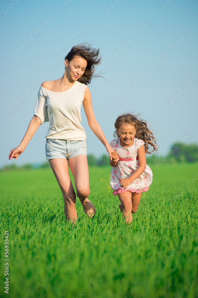 Young happy girls running at green wheat field Young happy girls running at green wheat field