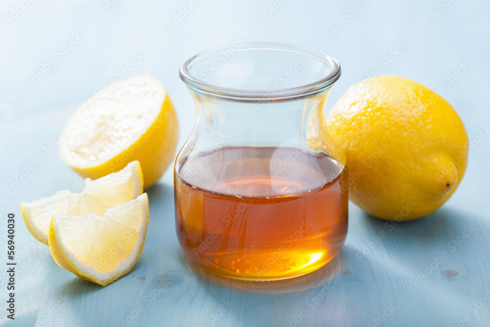 honey and lemon over blue background honey and lemon over blue background