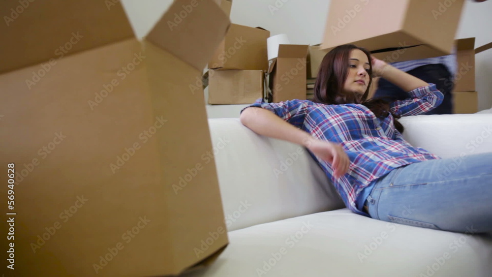 Girl and guy being tired of moving to their new home Girl and guy being tired of moving to their new home