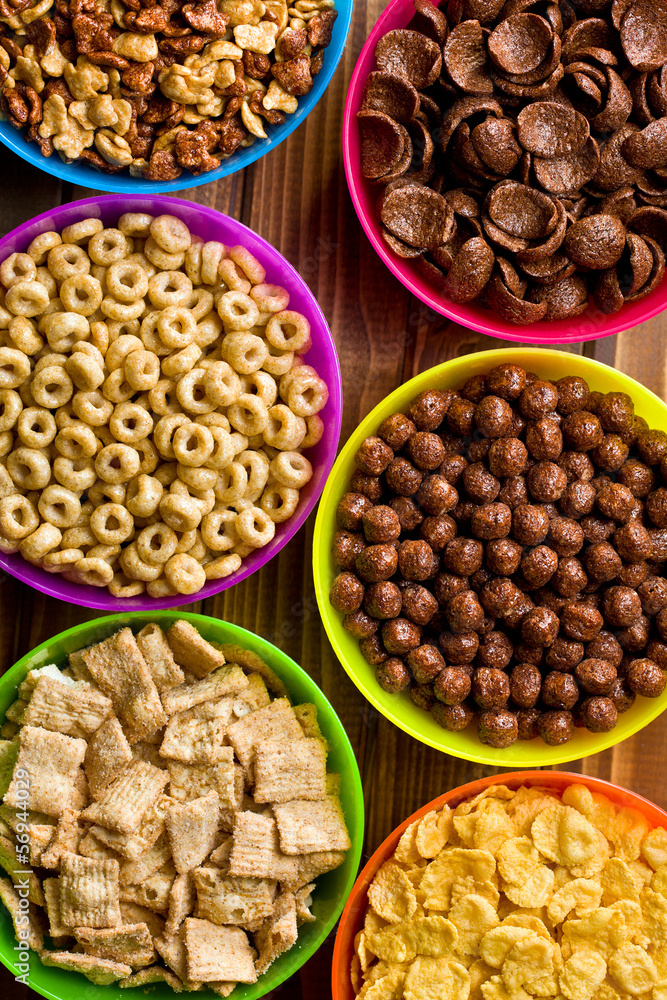 various kids cereals in plastic bowls various kids cereals in plastic bowls