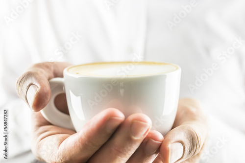 Holding cup of coffee